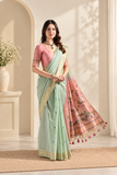 Elegant cotton saree featuring delicate floral motifs, woven border detailing, and a beautifully designed pallu with traditional tassel accents