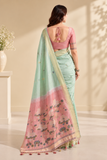 Elegant cotton saree featuring delicate floral motifs, woven border detailing, and a beautifully designed pallu with traditional tassel accents